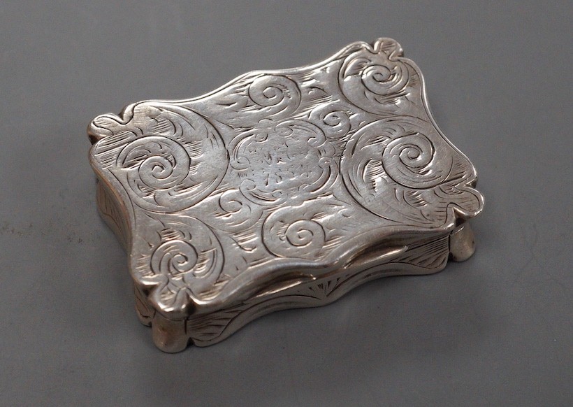 A Victorian engraved silver shaped rectangular snuff box, Edward Smith, London, 1855, 37mm (bale hole? on one side).
